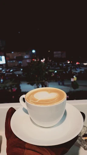 Hands holding a warm cup of coffee